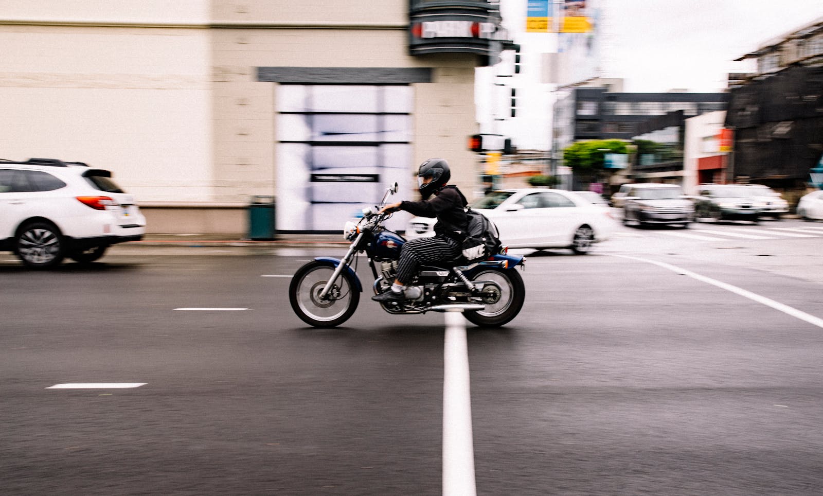 Motorcyclist speeds through a busy city street in San Francisco, California.